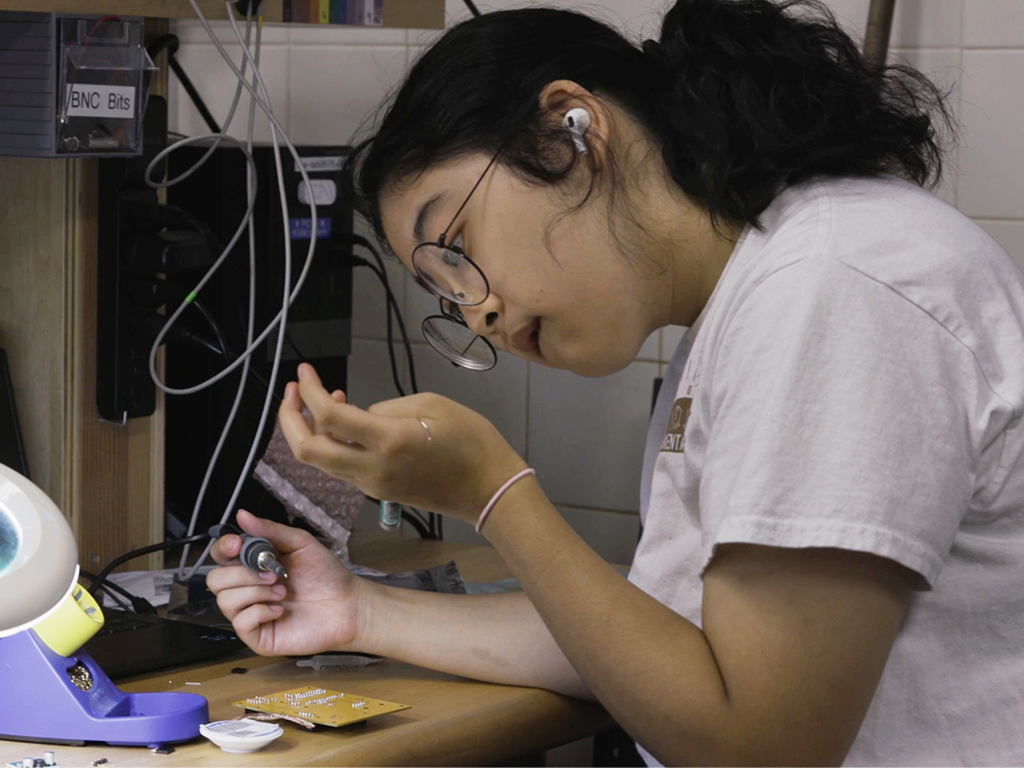 A photo of a student working on a project in a lab.