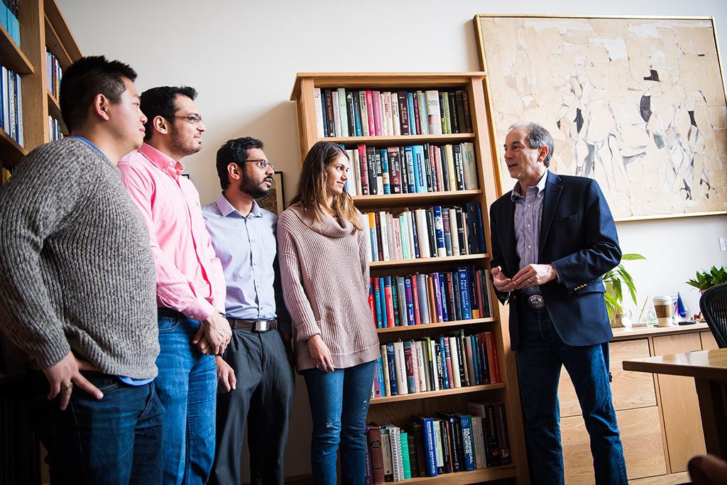 John Lienhard with students in his office